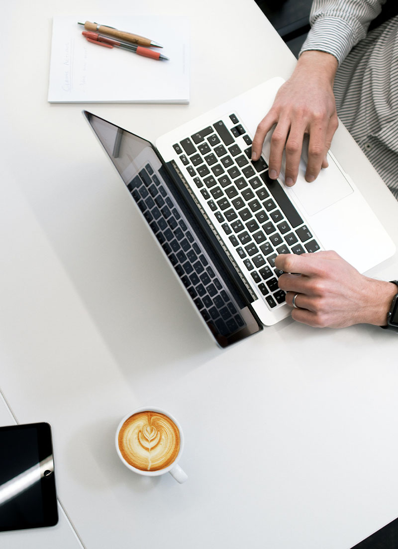 IT Consultant typing on macbook keyboard